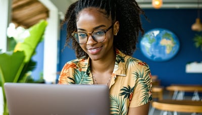 Jamaican professional exploring job opportunities abroad on a laptop